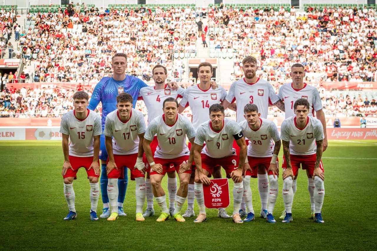 Drużyna Polski w piłce nożnej gotowa do gry, z trybunami pełnymi kibiców. Kiedy gra polska w piłkę nożną, emocje sięgają zenitu!